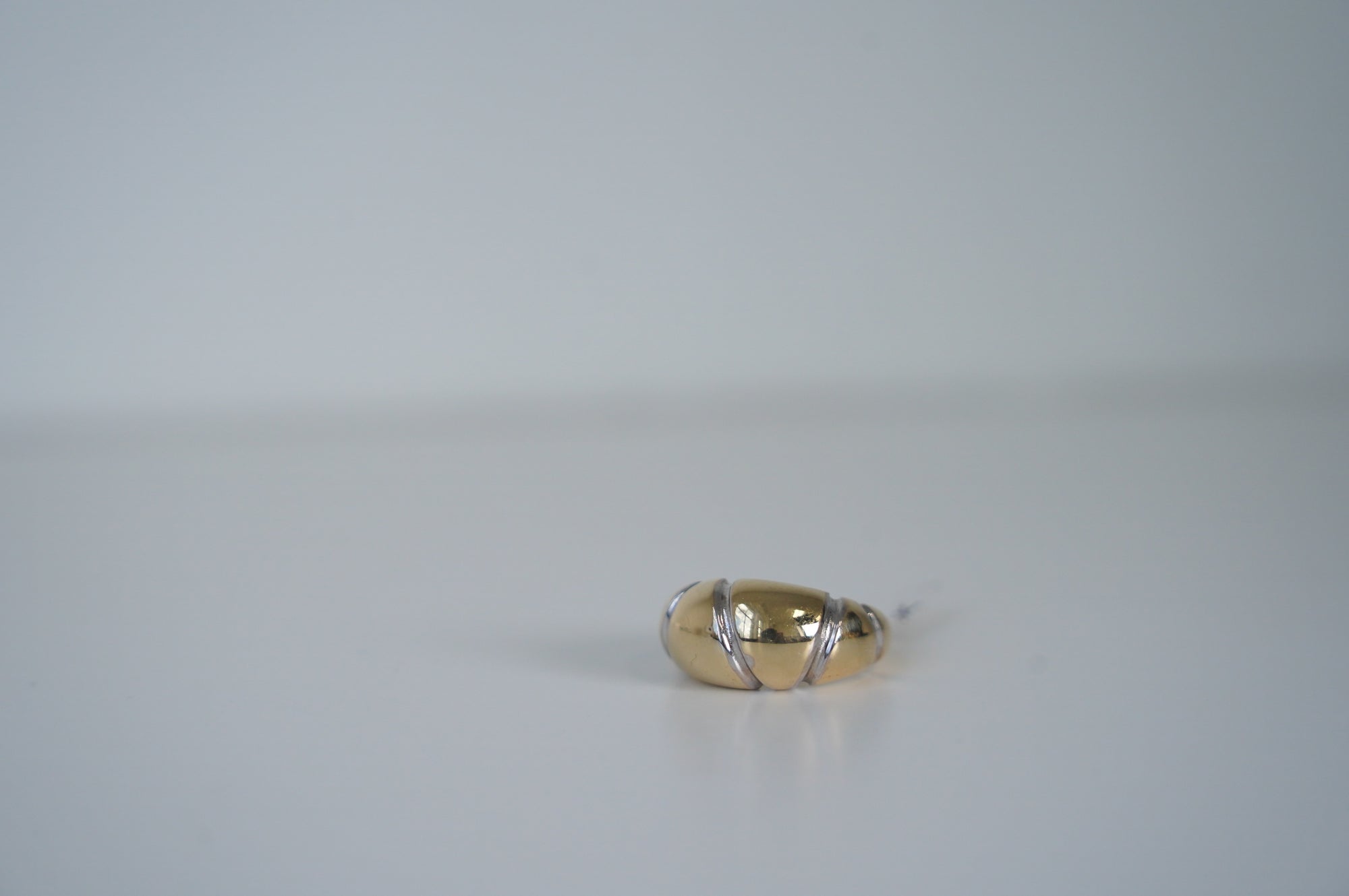 Elegant Gold Egg-Shaped Ring with Silver Details